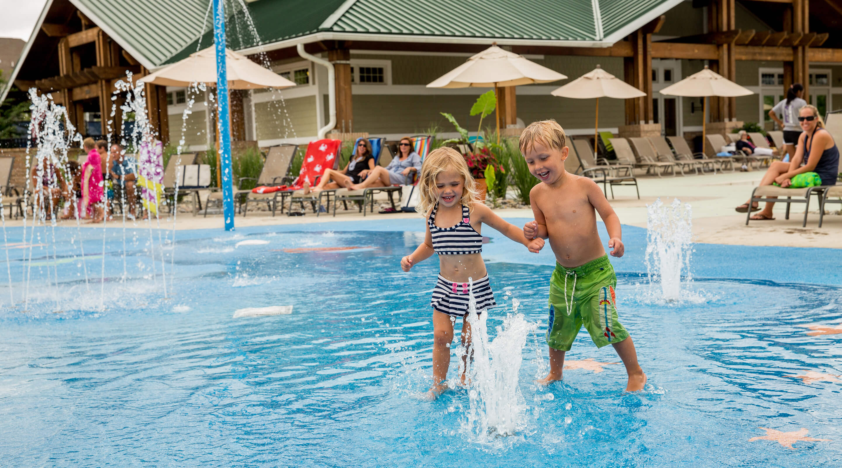 kids playing in a splash pool